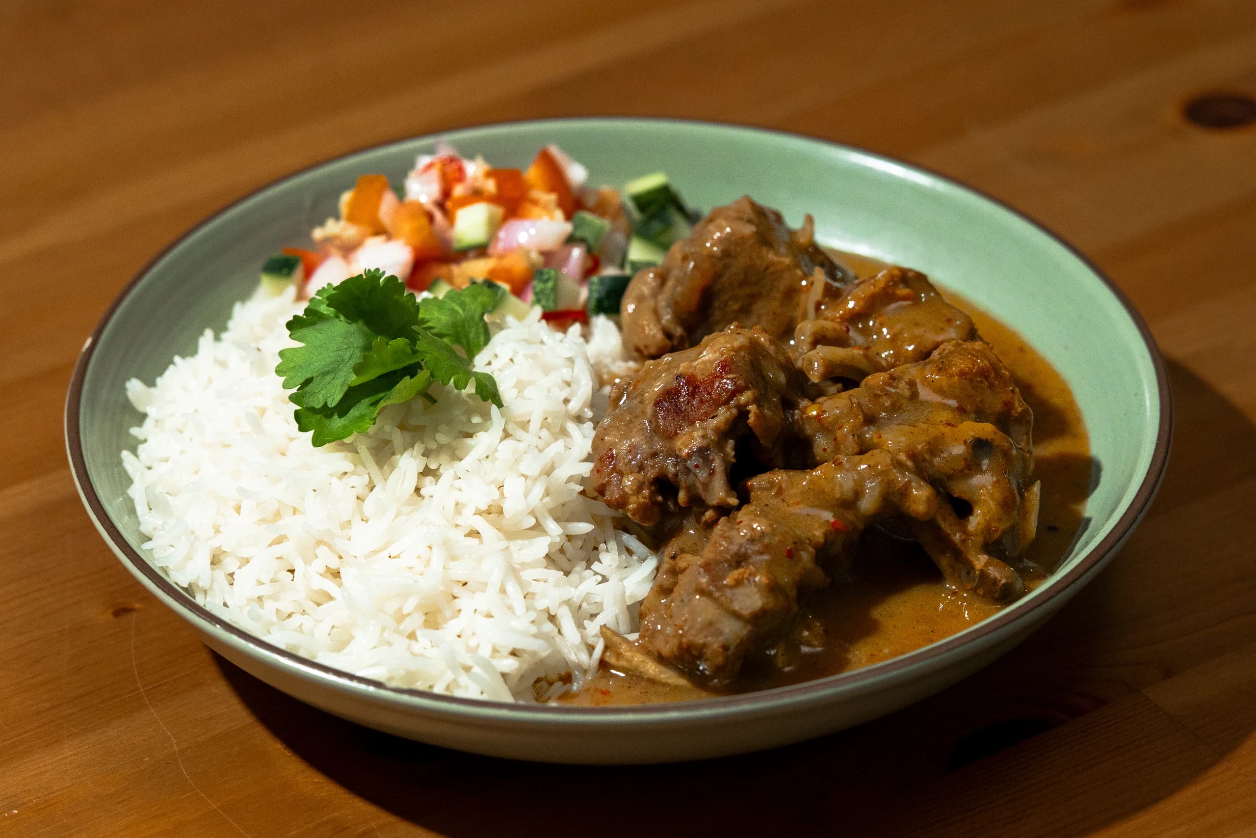 Food — Rice and curry on a green plate with fresh garnish