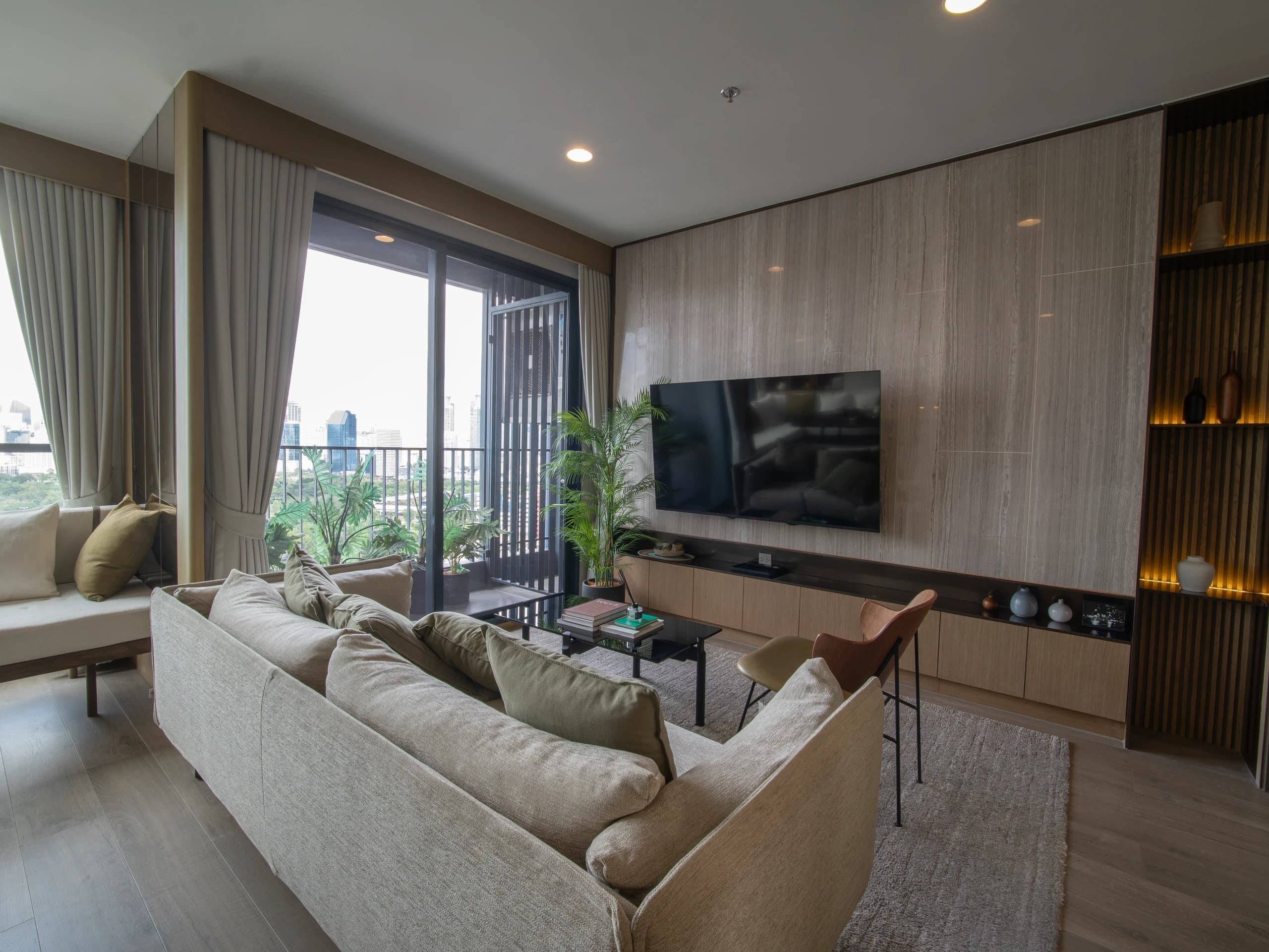 Room 2 (The Crown) — Living area with sofa, television, and floor-height windows